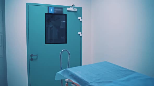 Blue door of the operating room and medical cart for carrying injured patients