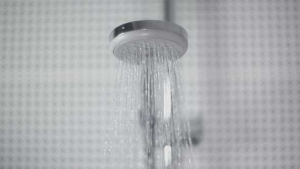 Close-Up of Turning on the Shower Head in Bathroom Water Sprays Out Flow Slowly in Front of Camera