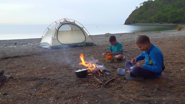 Children Eat Near the Fire