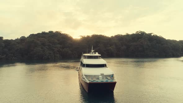 Drone footage during sunset from an elegant boat anchored at big river