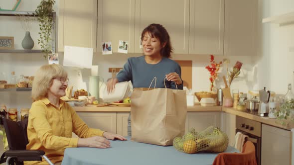 Woman Bringing Products To Senior Person