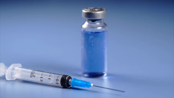 Close Up View of Ampoule and Syringe with Selective Focus.