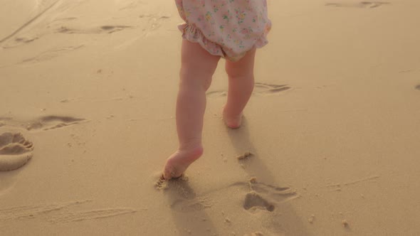 Closeup Feet Baby Learns to Walk on Beachside on Sand Unknown Barefoot Kid Toddler Child