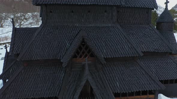 Borgund stave church from middle age - Detailed ascending aerial from entrance to top of tower