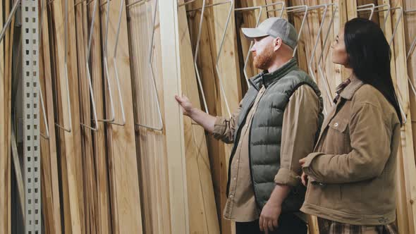 Couple Looking at Siding Panels at Store