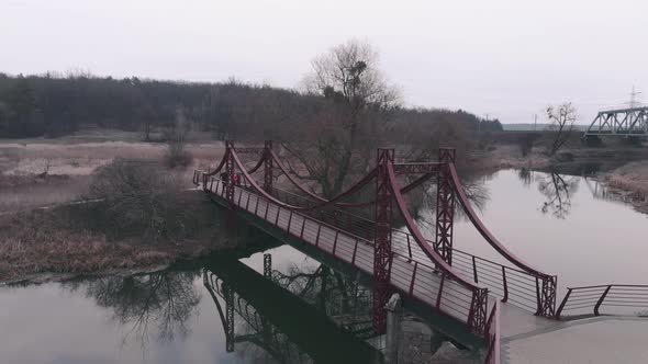 Woman and man running on bridge across river in city park. Running concept