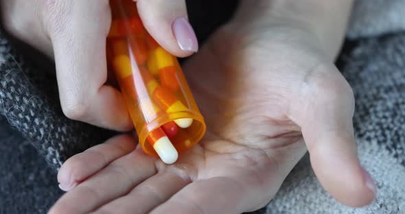 Person Pours Pills on Arm for Treatment Closeup