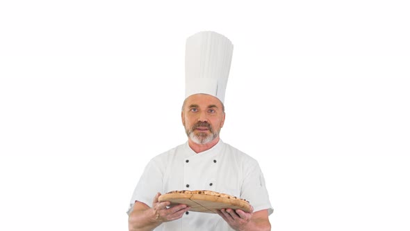 Attractive Cook with a Pizza in Hands Walking and Talking To Camera on White Background.