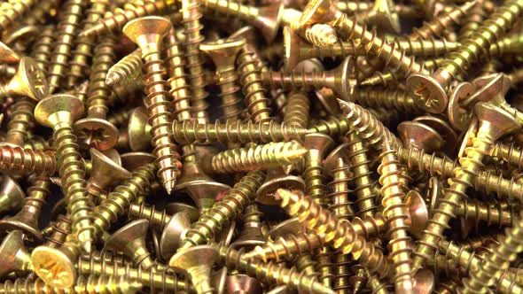 Golden Screws or Cross Head Screws Rotate Like Background Construction Supplies Selftapping Screws