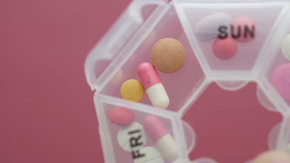 Close Up of Medical Pills in a Pill Box on Table