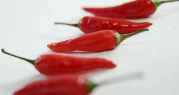 Red chili peppers on white background 4k