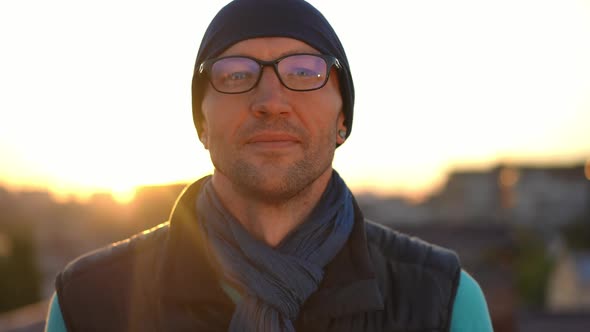 Closeup Front View Confident Caucasian Man in Eyeglasses Smiling Looking at Camera Posing in Sunrays