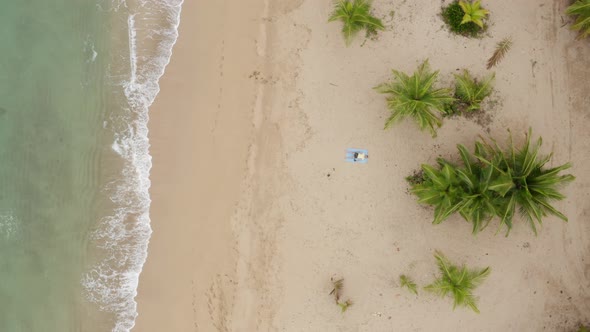 Drone view of a man lying on the beach