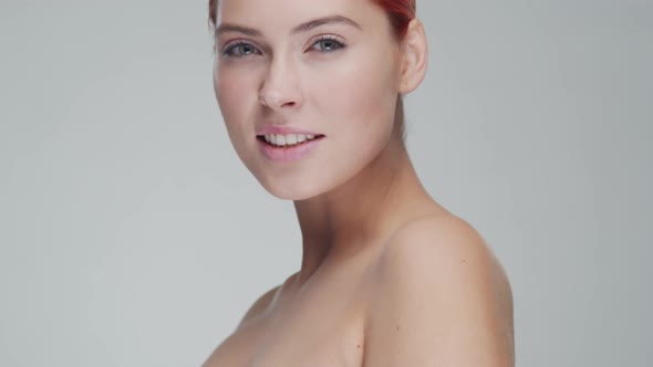 Studio portrait of young, beautiful and natural redhead woman. Beauty concept.