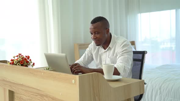 Smiling business black american man, African person working from home on table