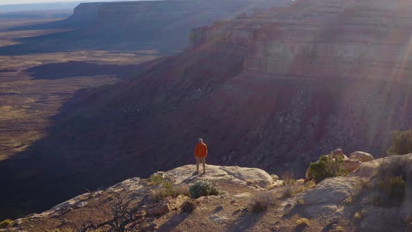 Aerial shot of a hiker at the the edge of Cedar Mesa in Utah