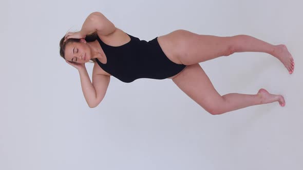 Beautiful Overweight Woman in Black Swimsuit on White Background