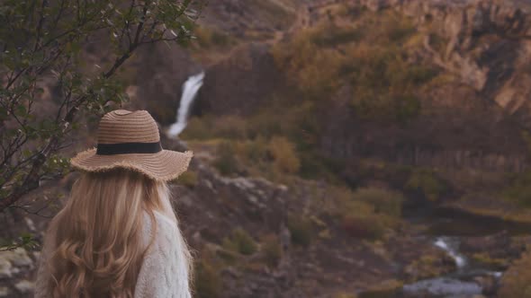 Woman Photographing Stream In Landscape