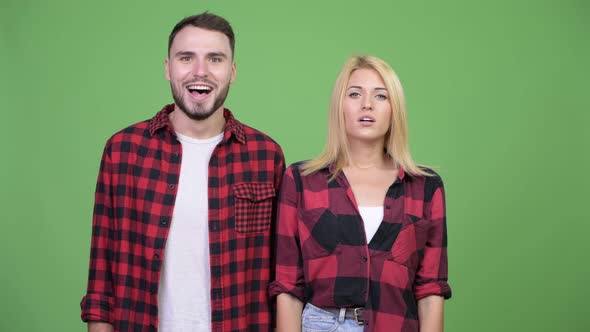 Young Man Giving Thumbs Up with Young Woman Having Headache Together