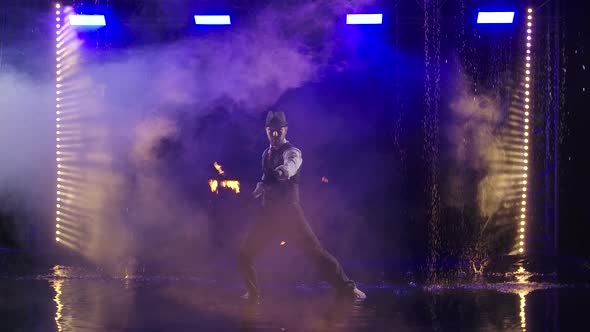 Fire Show in the Rain in the Studio. Professional Artist Performs a Variety of Fire Facilities