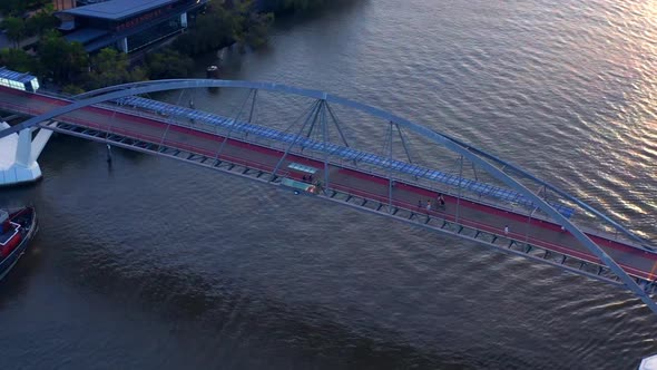 Pedestrians And Cyclists Crossing At The Goodwill Bridge In QLD, Australia. - aerial