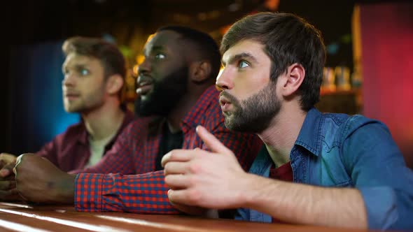 Football Fans Watching Game in Pub, Male Friends Disappointed With Team Lose