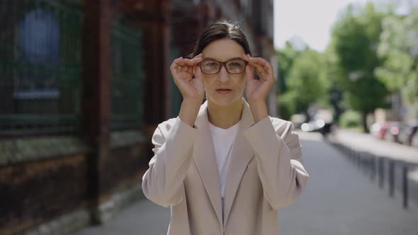 Portrait of Successful Business Woman Wearing Glasses and Crossed Her Arms Looking at the Camera