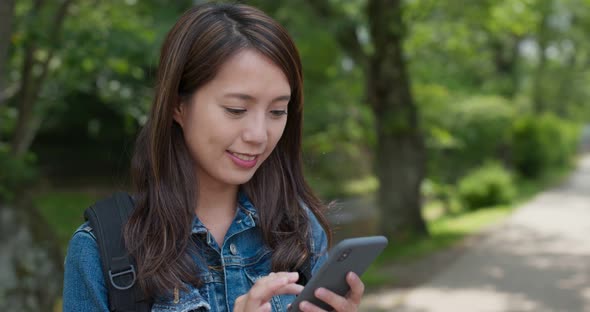 Woman use of mobile phone in the countryside