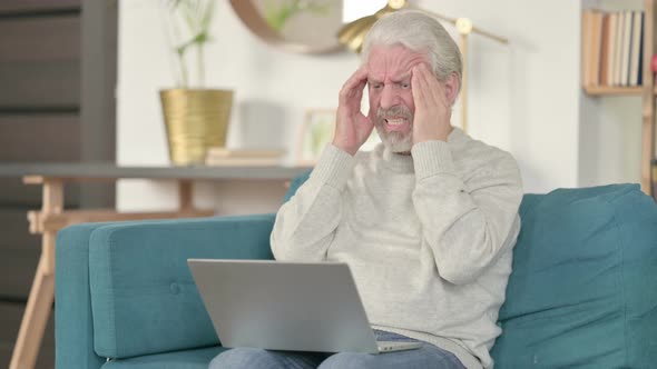 Old Man with Laptop Having Headache on Sofa 