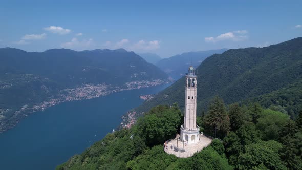 Aerial View Of The Faro Voltiano Overlooking Lake Como. Dolly Forward