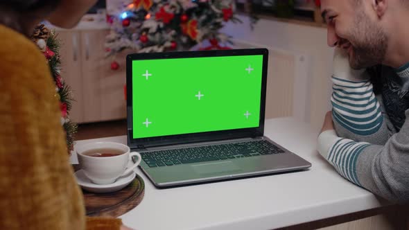 Festive Couple Looking at Horizontal Green Screen