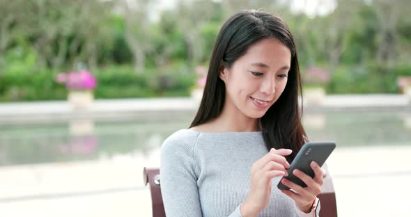 Woman use of mobile phone in the street