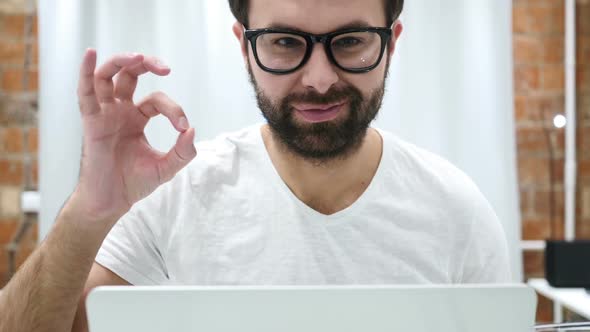 Okay Gesture By Young Beard Man at Work