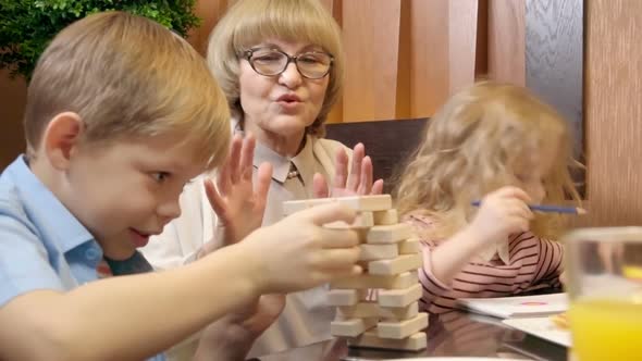 Old Lady Having Fun with Grandkids in Cafe