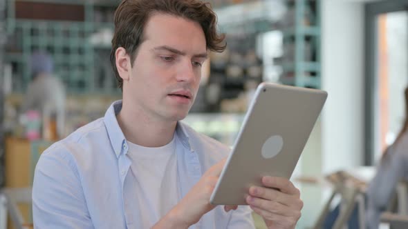 Portrait of Young Man Using Digital Tablet