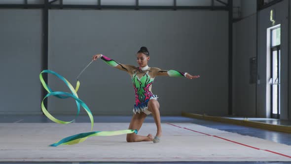 Female gymnast performing at sports hall