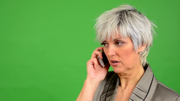 Business Middle Aged Woman Phone (Serious Face) - Green Screen - Studio - Closeup