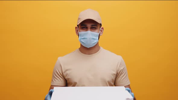 Delivery Man Smiling While Holding Pizza Boxes