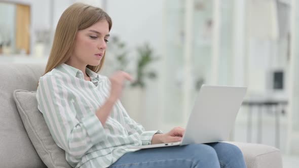 Tired Young Woman with Laptop Having Neck Pain at Home