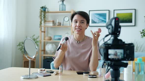 Professional Makeup Artist Recording Video Applying Decorative Cosmetics and Speaking to Camera
