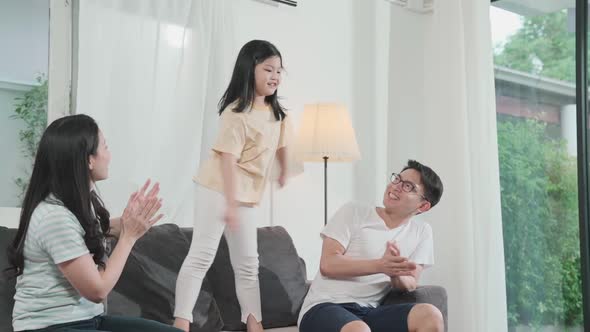 happiness asian mom dad daughter family enjoy dance moving together