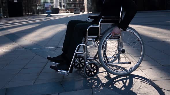 Businessman with in Wheelchair Turning Around To Camera with Happy Smile