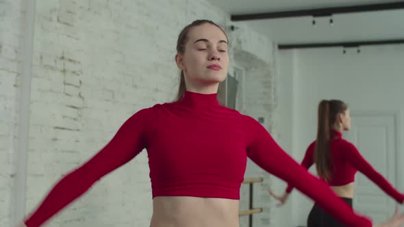 Portrait of Elegant Ballet Dancer Rehearsing in Studio