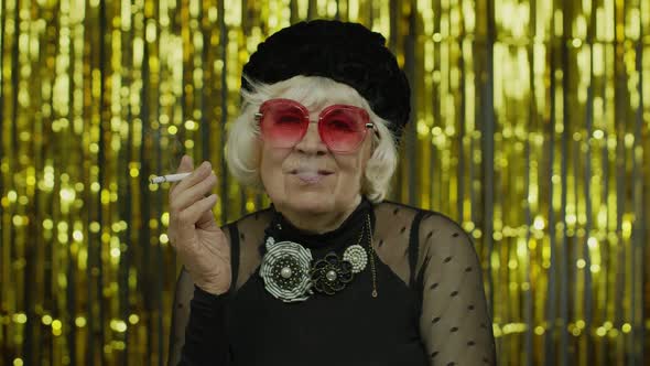 Elderly Style Mature Businesswoman in Fashion Black Clothes in Sunglasses Posing, Smoke Cigarette
