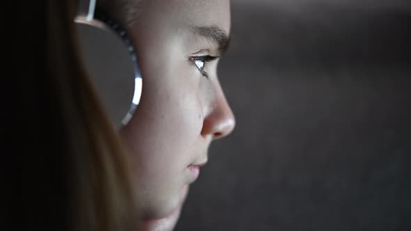 Girl with Headphones Listening Music