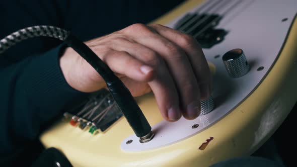 Guitarist Connects Amplifier To Bass Guitar Rotates Knobs