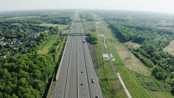 Aerial Drone Shot of Highway Traffic at Sunset Urban Transportation and Air Pollution