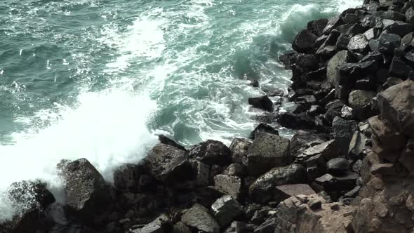 Waves crashing on rocks in Chorrillos, Lima, Peru SLOW MOTION