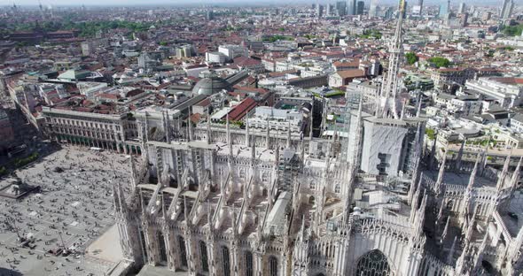 Stately Milan Cathedral and Piazza Duomo admired by tourists; top view