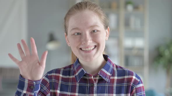 Young Woman Waving At the Camera